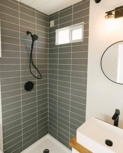a bathroom with a shower and a sink at Joshua Tree Tiny Home - Remote & Modern Container Home on 5 Acres in Joshua Tree