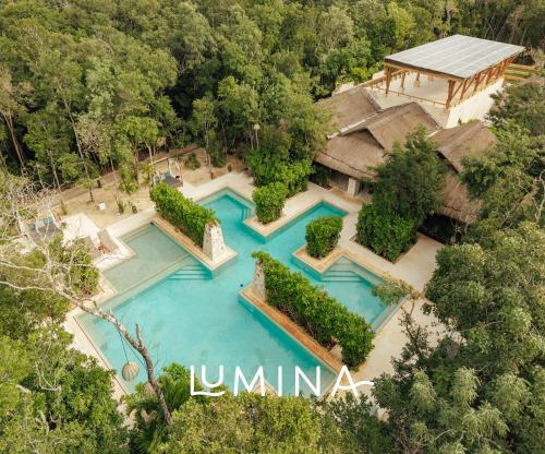 an aerial view of a house with two swimming pools at Lumina at LOSANTOS Tulum in Tulum
