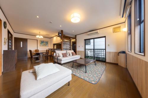 a living room with a couch and a table at Tabiudo Souwa in Takayama