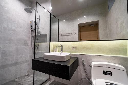 a bathroom with a sink and a mirror at The Moon Huahin Pool Villa in Hua Hin