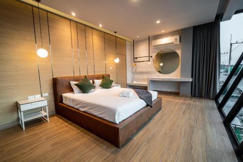 a bedroom with a large bed and a window at The Moon Huahin Pool Villa in Hua Hin