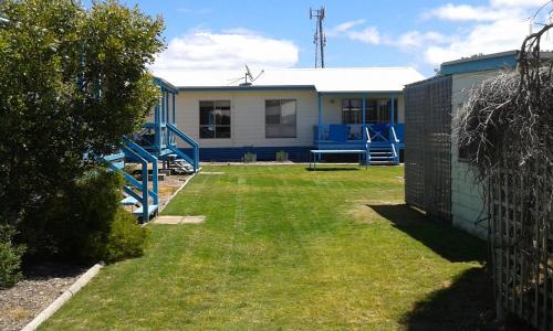 a house with a yard in front of it at Marion Bay Holiday Villas in Marion Bay