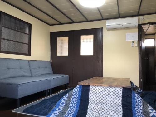 a living room with a couch and a table at Yokohama Sakae-chou Ninja House #JA1 in Yokohama