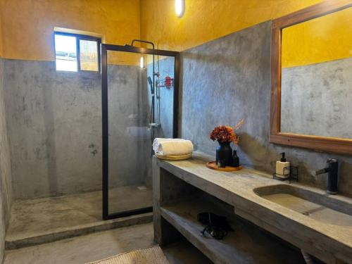 a bathroom with a shower and a sink at Happy Villas in Paje