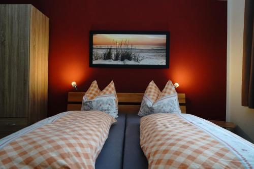 a bedroom with two beds and a picture on the wall at Ferienwohnung Schog in Todtnau