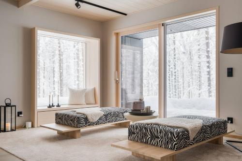 a living room with two beds and a window at Arctic Design Villa Levi in Levi