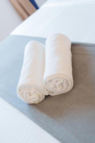two rolled up towels sitting on top of a table at St Anthonys Holiday Inn in Kotagala