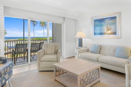 a living room with a couch and a table at Beach Villas 2514 condo in Captiva