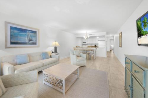 a living room with a couch and a table at Beach Villas 2514 condo in Captiva