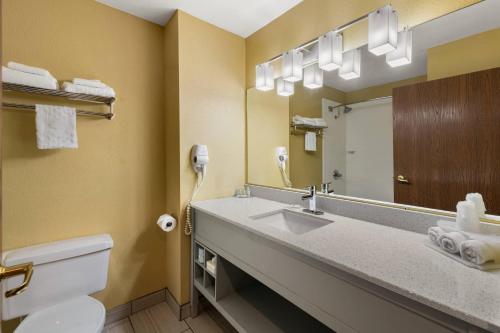 a bathroom with a sink and a mirror at Quality Inn Warrensburg in Warrensburg
