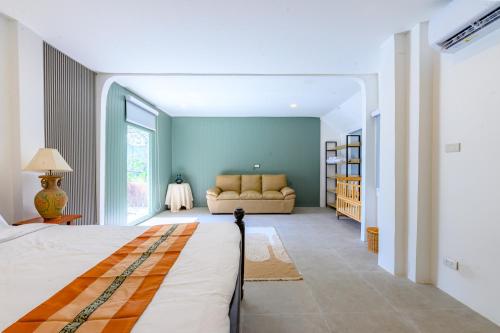 a bedroom with a bed and a couch in a room at Mountain View Escape at Primrose Hill in Bangrak Beach