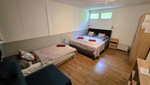 a room with two beds and a couch in it at Gesztenyés Üdülő in Balatonudvari