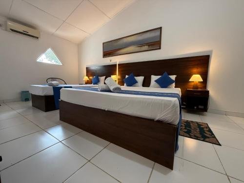 a large bedroom with a large bed and a desk at Hotel sunflower in Dambulla