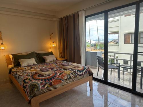 a bedroom with a bed with a view of a balcony at Nest by Aerial Lanta in Ko Lanta