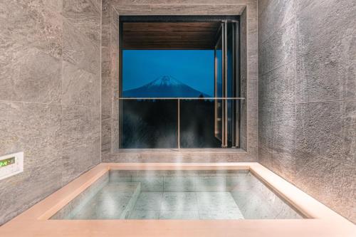 a swimming pool with a view of a mountain through a window at なか富士 -Nakafuji- in Fujinomiya