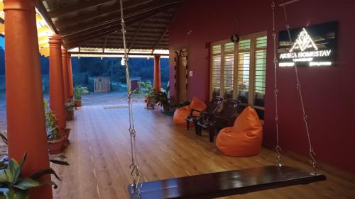 a living room with a porch with a swing at Aksha Homestay in Sakleshpur