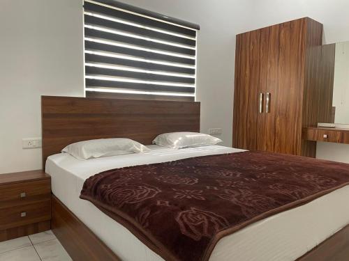 a large bed in a bedroom with a window at Dream Castle in Cochin