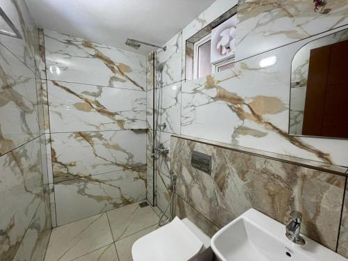 a bathroom with a sink and a shower and a toilet at Dream Castle in Cochin