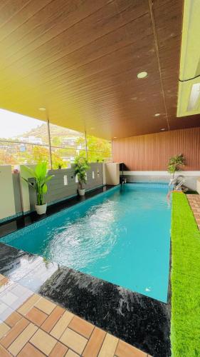 a large swimming pool on top of a building at Shubh causy 4bhk villa in Lonavala