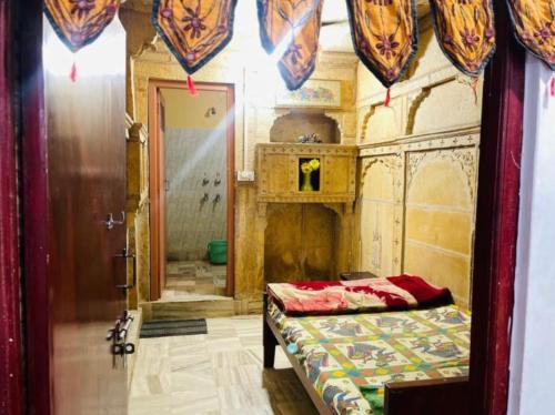 a bedroom with a bed in a room with a fireplace at The Jeet Mahal Hotel in Jaisalmer