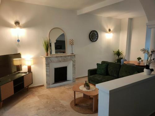 a living room with a couch and a fireplace at Maison Corse avec SPA - La Casa Serena in Ortiporio