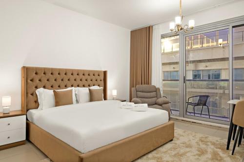 a bedroom with a large bed and a large window at FIRST CLASS Studio Pacific Shores Retreat in Ras al Khaimah