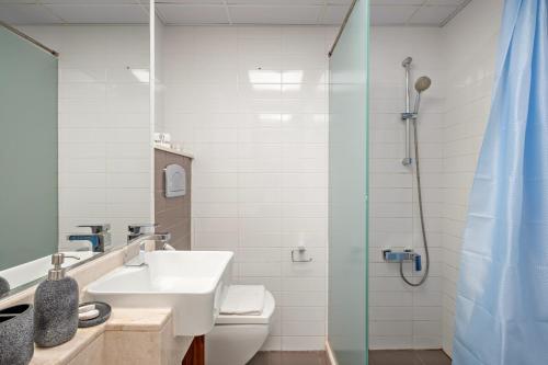 a bathroom with a sink and a shower at FIRST CLASS Studio Pacific Shores Retreat in Ras al Khaimah
