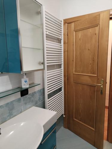 a bathroom with a sink and a wooden cabinet at Casa vacanze tortoi in Candide