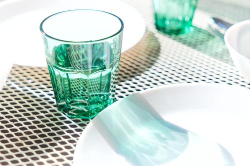 a glass vase sitting on a table next to a sink at Base Hanegi Apartment by Tranova in Tokyo