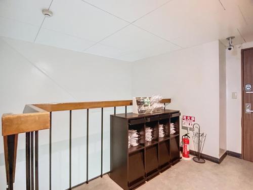 a room with a shelf with wine bottles on it at キュリナリーBed and Art in Hamamatsu