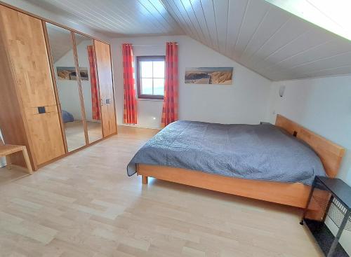 a bedroom with a bed and a window in it at Haus Probst in Bischofsmais