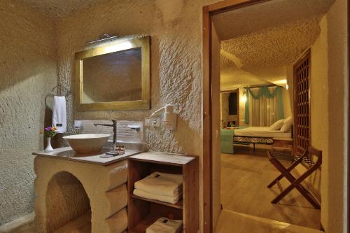a bathroom with a sink and a mirror at Jacob's Cave Suites - Cappadocia in Göreme