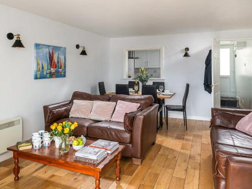 a living room with a couch and a table at Harbour View in Cemaes Bay