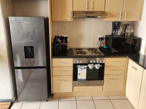 a kitchen with a stainless steel refrigerator and a stove at 13 at Santos in Mossel Bay