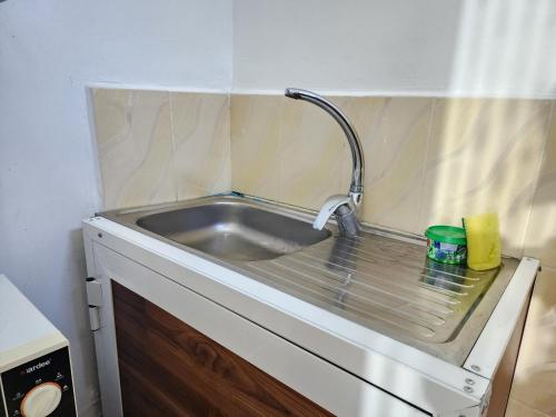 a kitchen sink with a faucet on top of it at MaTemu Square in Mapinga