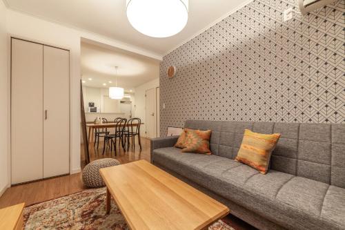 a living room with a couch and a table at Eldor Nishikoujiya Apartment by Tranova in Tokyo