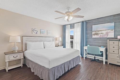 a bedroom with a bed and a ceiling fan at Emerald Isle 708 in Fort Walton Beach