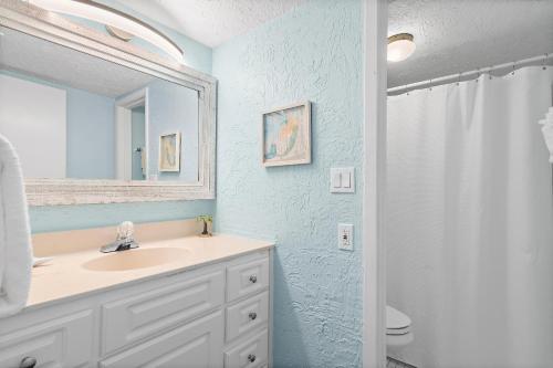 a bathroom with a sink and a mirror at Emerald Isle 708 in Fort Walton Beach