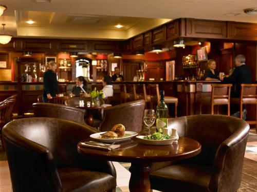 a restaurant with a table and chairs and a bar at Downings Bay Hotel in Downings