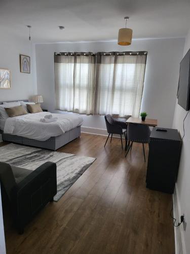 a bedroom with a bed and a table and a dining room at Double room in Stone in Kent