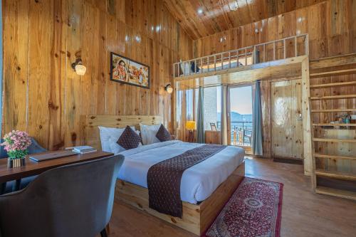 a bedroom with a bed and a desk at The Golden Castle Hotels in Mukteshwar