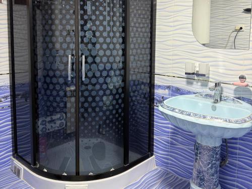 a bathroom with a sink and a shower at Hostel Azizjon in Samarkand