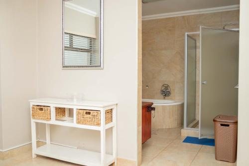 a bathroom with a sink and a mirror at Don Self Catering in Walvis Bay