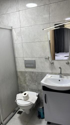 a bathroom with a toilet and a sink and a mirror at Retro Boutique in Istanbul
