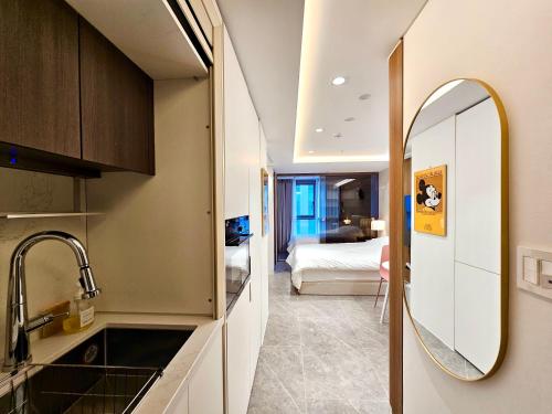 a kitchen with a sink and a mirror in a room at Cookie House in Seoul