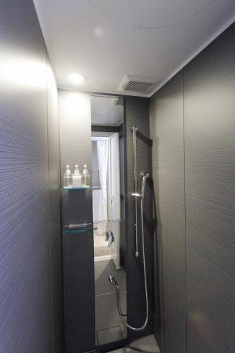 a bathroom with a shower with a glass door at precious days inn in Fukuoka