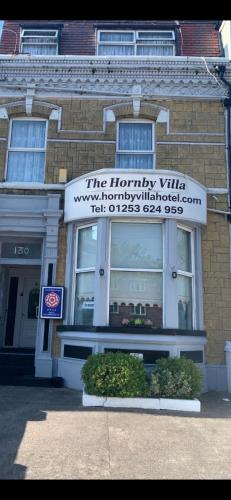 a building with a sign on the front of it at Hornby Villa B&B Couples & Families Only- Quiet Central Location- Near To Winter Gardens in Blackpool