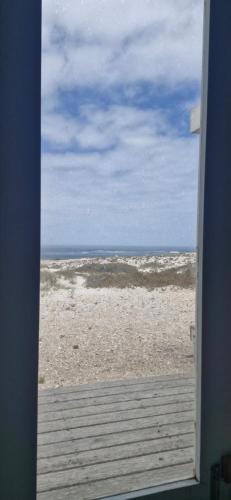 a view of the beach from a door of a house at KaiKaiView in Port Nolloth