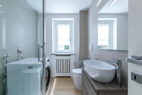 a white bathroom with a sink and a toilet at Blanc 4810 in Pré-Saint-Didier