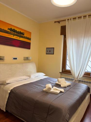 a bedroom with a bed with towels on it at Bis Jolly 1 in Cosenza